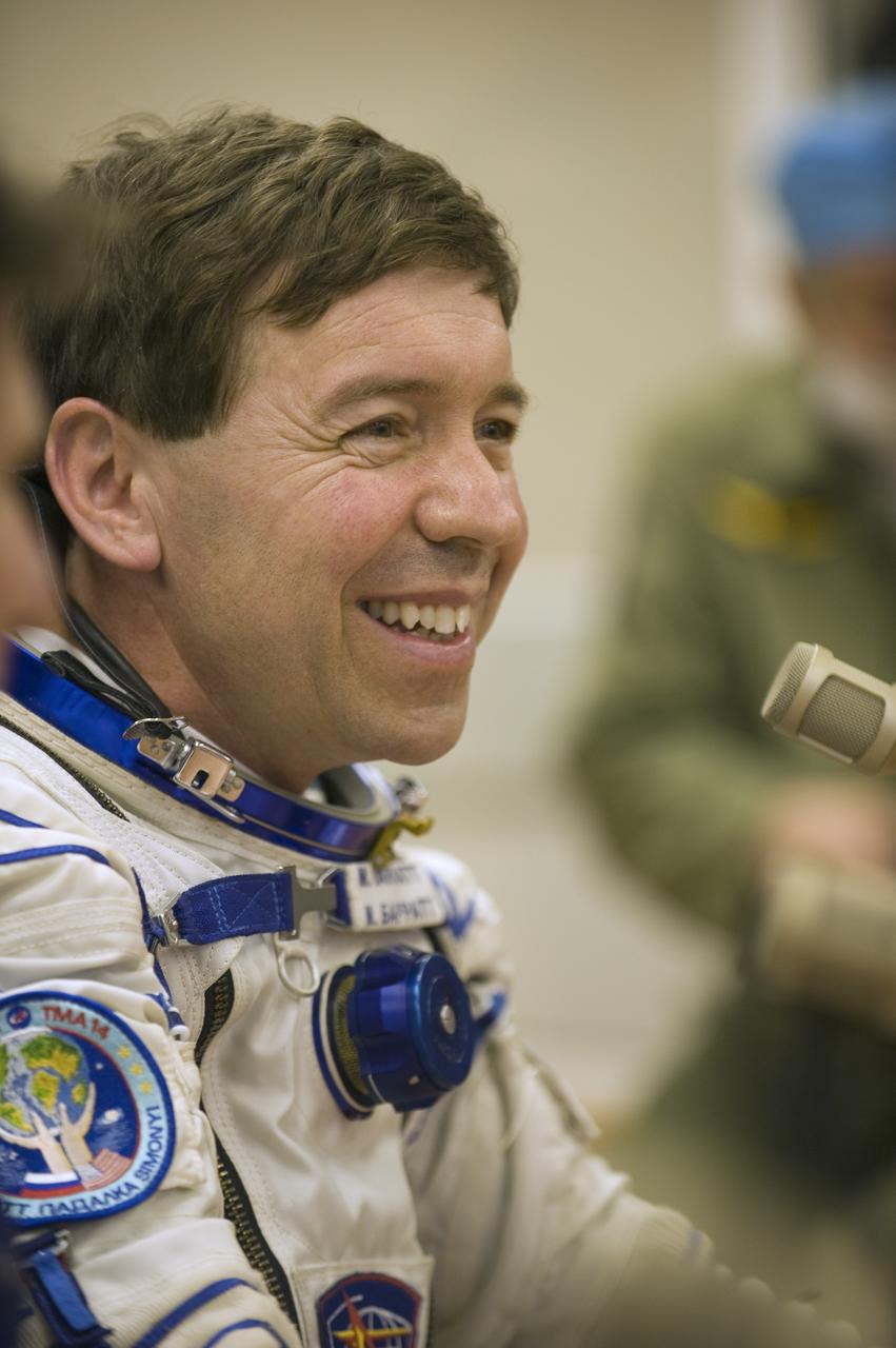Expedition 19 Flight Engineer Michael R. Barratt, smiles to family and colleagues in the suit up room of building 254, Thursday, March 26, 2009 in Baikonur, Kazakhstan. (Photo Credit: NASA/Bill Ingalls)