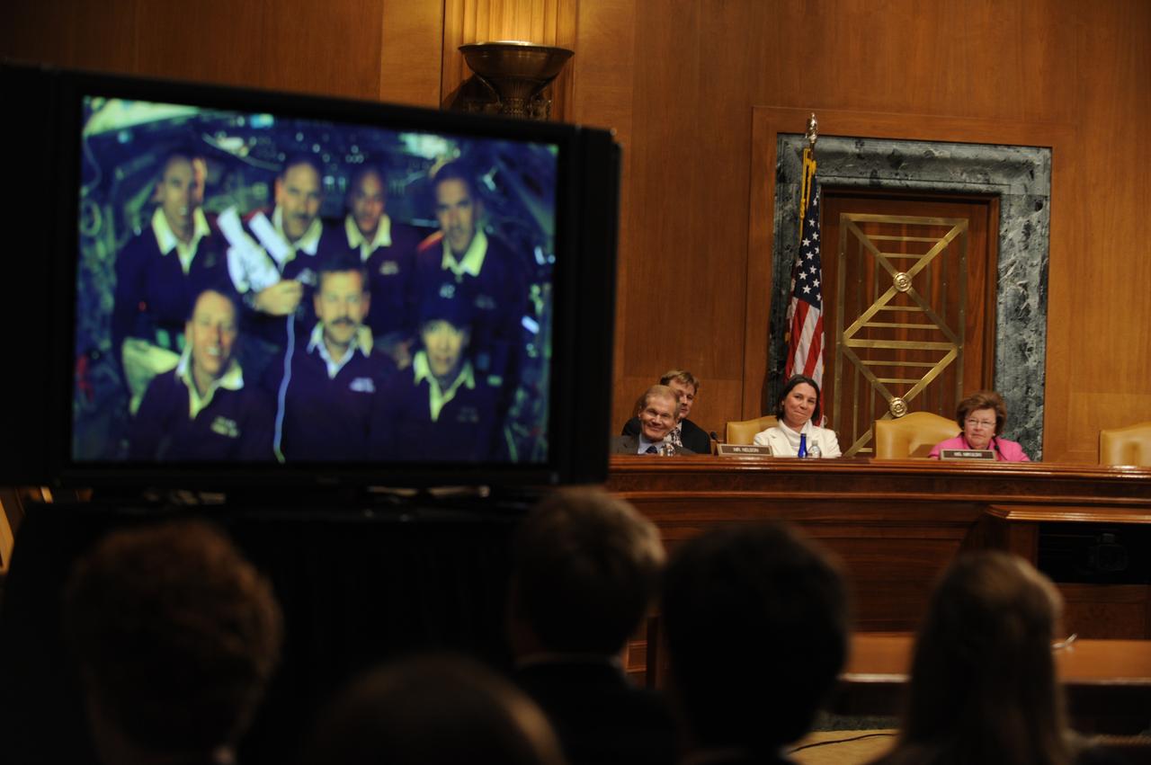U.S. Sen. Barbara Mikulski, D-Md., rear right, speaks to the crew of STS-125, during a televised phone call to the space shuttle, Thursday, May 21, 2009, in a Dirksen Senate office building hearing room on Capitol Hill in Washington as Sen. Bill Nelson, D-Fla., rear left, looks on. The crew of STS-125 is returning to earth after finishing repairs on the Hubble Space Telescope. Photo Credit: (NASA/Paul E. Alers)