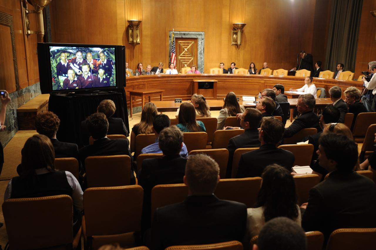 U.S. Sen. Barbara Mikulski, D-Md., rear right, and Sen. Bill Nelson, rear left, speak to the crew of STS-125, during a televised phone call to the space shuttle, Thursday, May 21, 2009, in a Dirksen Senate office building hearing room on Capitol Hill in Washington. The crew of STS-125 is returning to earth after finishing repairs on the Hubble Space Telescope. Photo Credit: (NASA/Paul E. Alers)