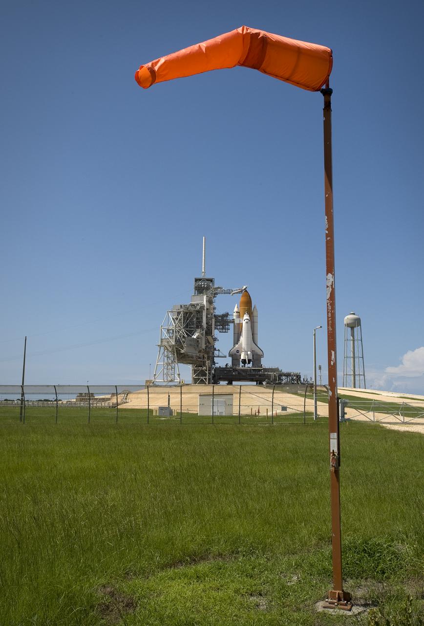 The space shuttle Endeavour is framed by a windsock at launch pad 39A at  the NASA Kennedy Space Center in Cape Canaveral, Florida on Saturday, July 11, 2009.  NASA is hopeful that Endeavour will launch with the crew of STS-127 on Sunday.  Photo Credit: (NASA/Bill Ingalls)