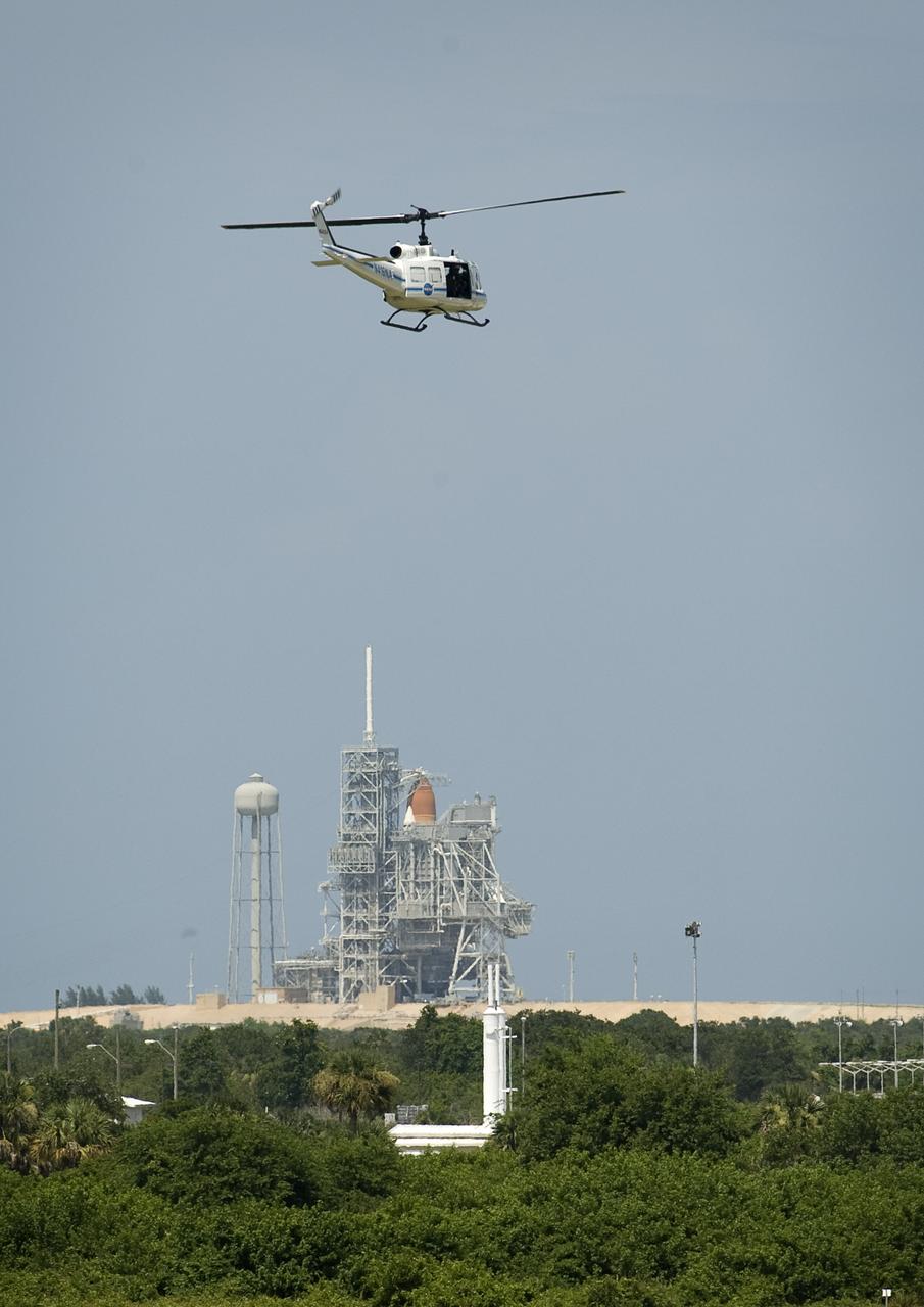 A NASA Security helicopter watches over the Astrovan as it takes the crew of STS-127 to the space shuttle Endeavour at pad 39a at NASA's Kennedy Space Center in Cape Canaveral, Florida, Sunday, July 12, 2009. Endeavour is set to launch at 7:13p.m. EDT with the crew of STS-127 and start a 16-day mission that will feature five spacewalks and complete construction of the Japan Aerospace Exploration Agency's Kibo laboratory. Photo Credit: (NASA/Bill Ingalls)
