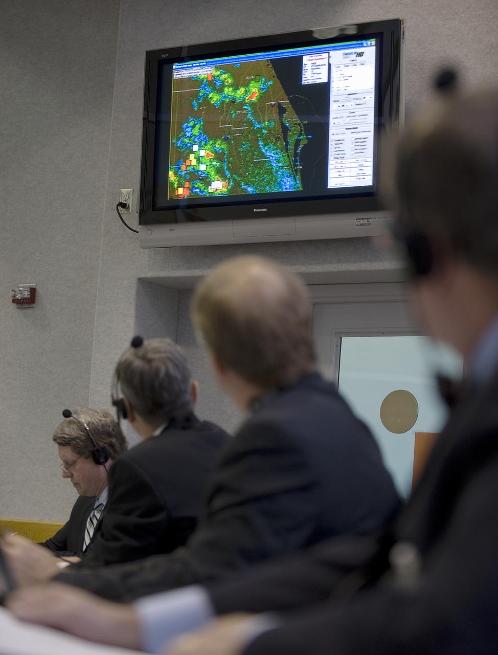 NASA mission managers watch the latest weather radar on a monitor in Firing Room Four of the Launch Control Center at NASA's Kennedy Space Center in Cape Canaveral, Florida, Sunday, July 12, 2009. Endeavour is set to launch at 7:13p.m. EDT with the crew of STS-127 and start a 16-day mission that will feature five spacewalks and complete construction of the Japan Aerospace Exploration Agency's Kibo laboratory. Photo Credit: (NASA/Bill Ingalls)