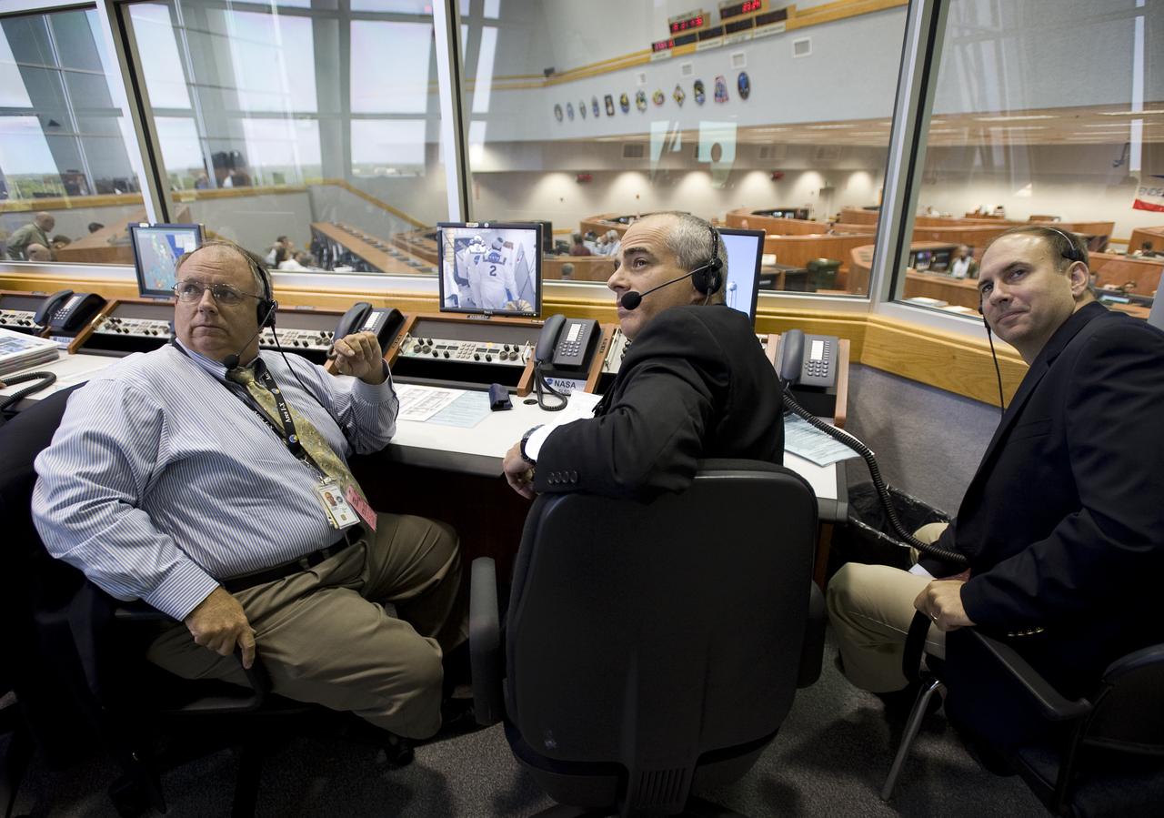NASA mission managers watch the latest weather radar on a monitor in Firing Room Four of the Launch Control Center at NASA's Kennedy Space Center in Cape Canaveral, Florida, Sunday, July 12, 2009. Endeavour is set to launch at 7:13p.m. EDT with the crew of STS-127 and start a 16-day mission that will feature five spacewalks and complete construction of the Japan Aerospace Exploration Agency's Kibo laboratory. Photo Credit: (NASA/Bill Ingalls)