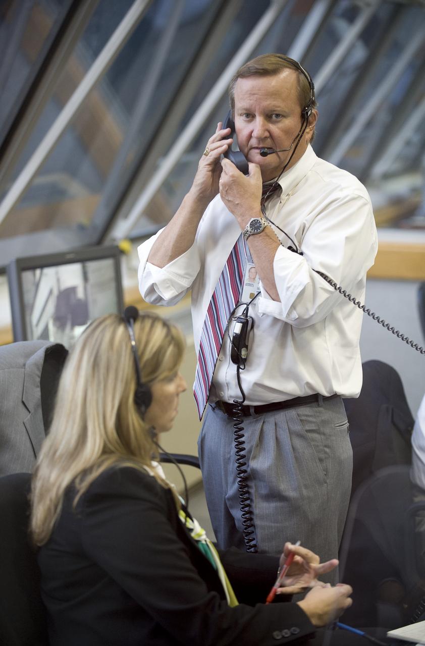 NASA Shuttle Launch Director Michael Leinbach talks on the phone from Firing Room Four of the Launch Control Center at NASA's Kennedy Space Center in Cape Canaveral, Florida, Sunday, July 12, 2009. THe space shuttle Endeavour is set to launch at 7:13p.m. EDT with the crew of STS-127 and start a 16-day mission that will feature five spacewalks and complete construction of the Japan Aerospace Exploration Agency's Kibo laboratory. Photo Credit: (NASA/Bill Ingalls)