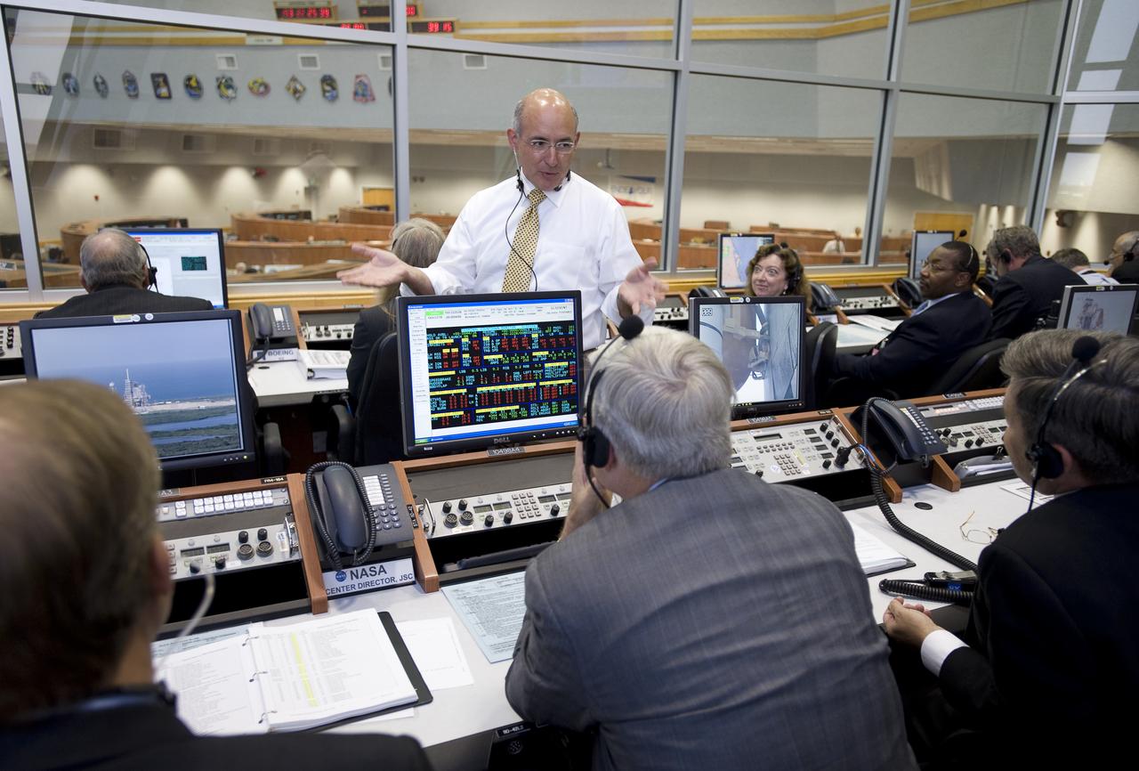 Mike Suffredini, NASA Manager, International Space Station (ISS) Program, talks with other NASA mission managers in from Firing Room Four of the Launch Control Center at NASA's Kennedy Space Center in Cape Canaveral, Florida, Sunday, July 12, 2009. The space shuttle Endeavour is set to launch at 7:13p.m. EDT with the crew of STS-127 and start a 16-day mission that will feature five spacewalks and complete construction of the Japan Aerospace Exploration Agency's Kibo laboratory. Photo Credit: (NASA/Bill Ingalls)