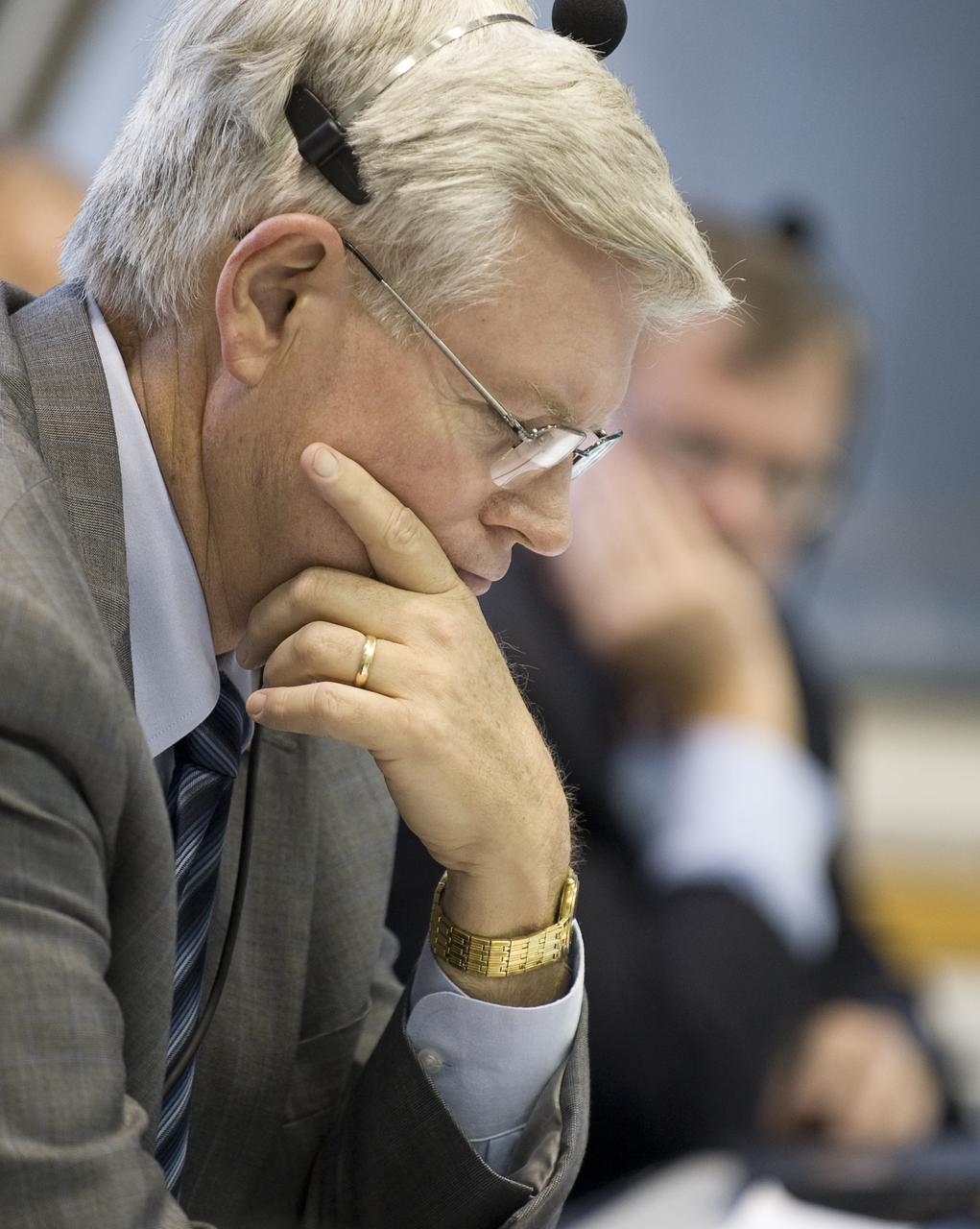 NASA Johnson Space Center Director Michael Coats monitors the launch team discussions on his headset from Firing Room Four of the Launch Control Center at NASA's Kennedy Space Center in Cape Canaveral, Florida, Sunday, July 12, 2009. The space shuttle Endeavour is set to launch at 7:13p.m. EDT with the crew of STS-127 and start a 16-day mission that will feature five spacewalks and complete construction of the Japan Aerospace Exploration Agency's Kibo laboratory. Photo Credit: (NASA/Bill Ingalls)