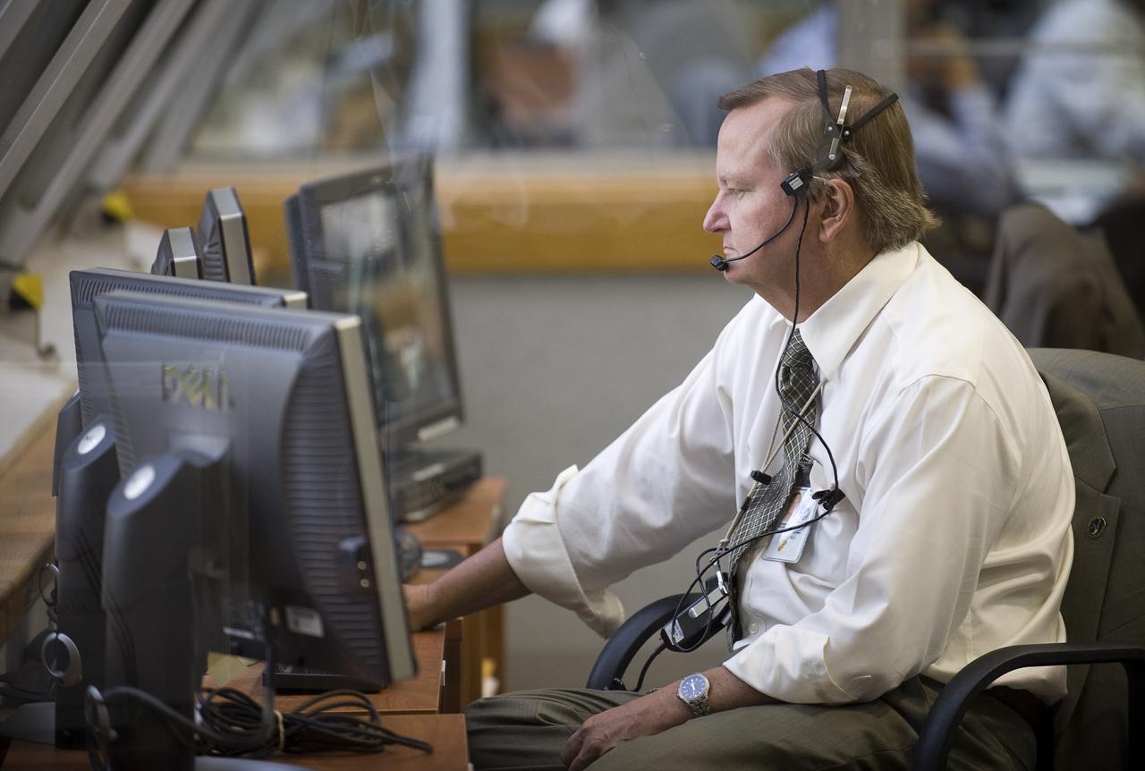 Mike Leinbach, NASA Assistant Shuttle Launch Director for the STS-127 mission, monitors the launch countdown progress and local weather from Firing Room Four of the Launch Control Center at NASA's Kennedy Space Center in Cape Canaveral, Florida, Monday, July 13, 2009. The space shuttle Endeavour is set to launch at 6:51p.m. EDT with the crew of STS-127 and start a 16-day mission that will feature five spacewalks and complete construction of the Japan Aerospace Exploration Agency's Kibo laboratory. Photo Credit: (NASA/Bill Ingalls)