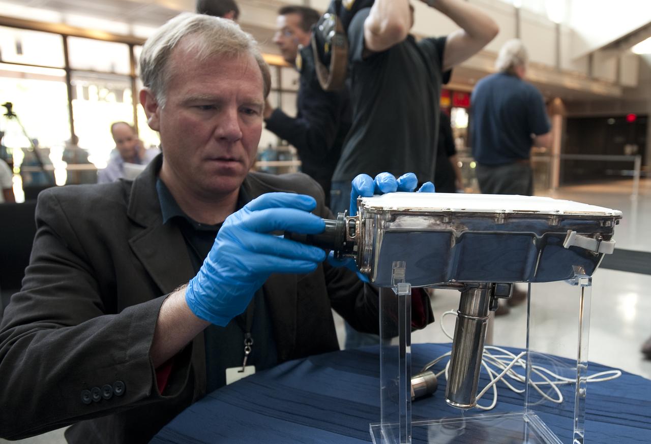 Mike Simons, Director of the National Electronic Museum in Baltimore, Maryland assembles an Apollo TV camera for display prior to NASA's briefing to release restored Apollo 11 moonwalk footage at the Newseum, Thursday, July 16, 2009, in Washington, DC.  Photo Credit: (NASA/Bill Ingalls)