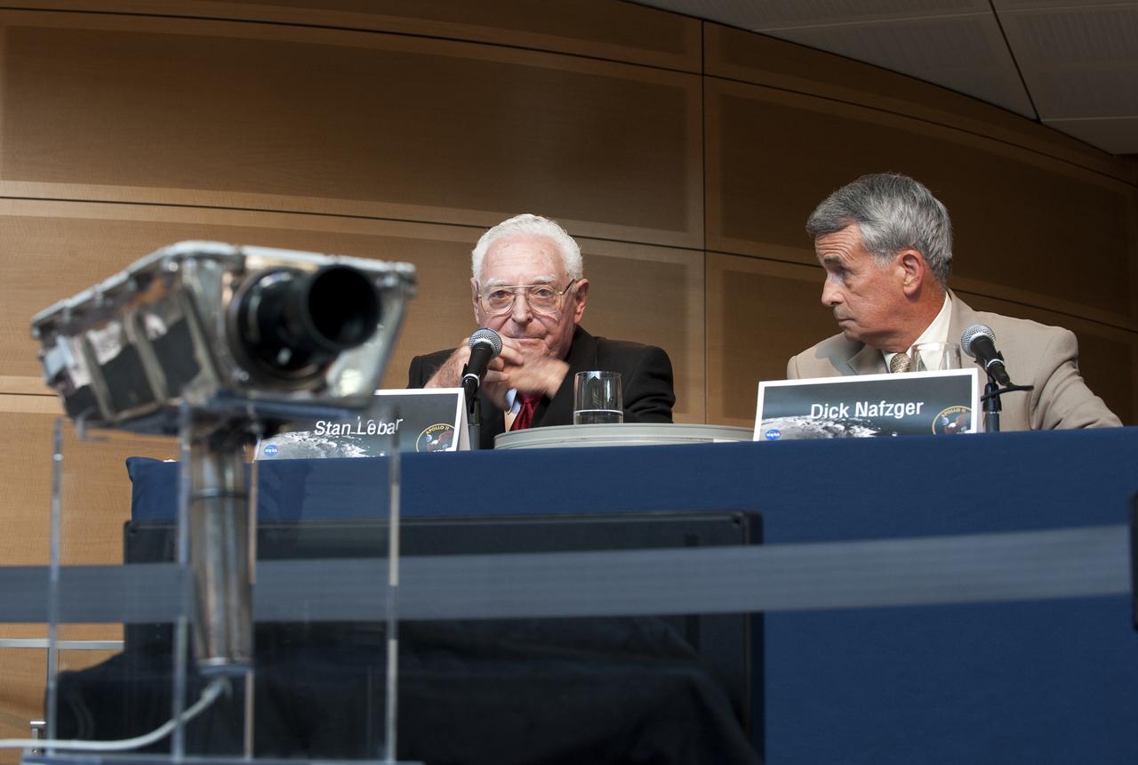 Stan Lebar, former Westinghouse Electric program manager, left, talks about the Apollo era TV cameras such as the one on display in the foreground as Richard Nafzger, team lead and Goddard engineer, listens at NASA's briefing where restored Apollo 11 moonwalk footage was revealed for the first time at the Newseum, Thursday, July 16, 2009, in Washington, DC.  Photo Credit: (NASA/Bill Ingalls)