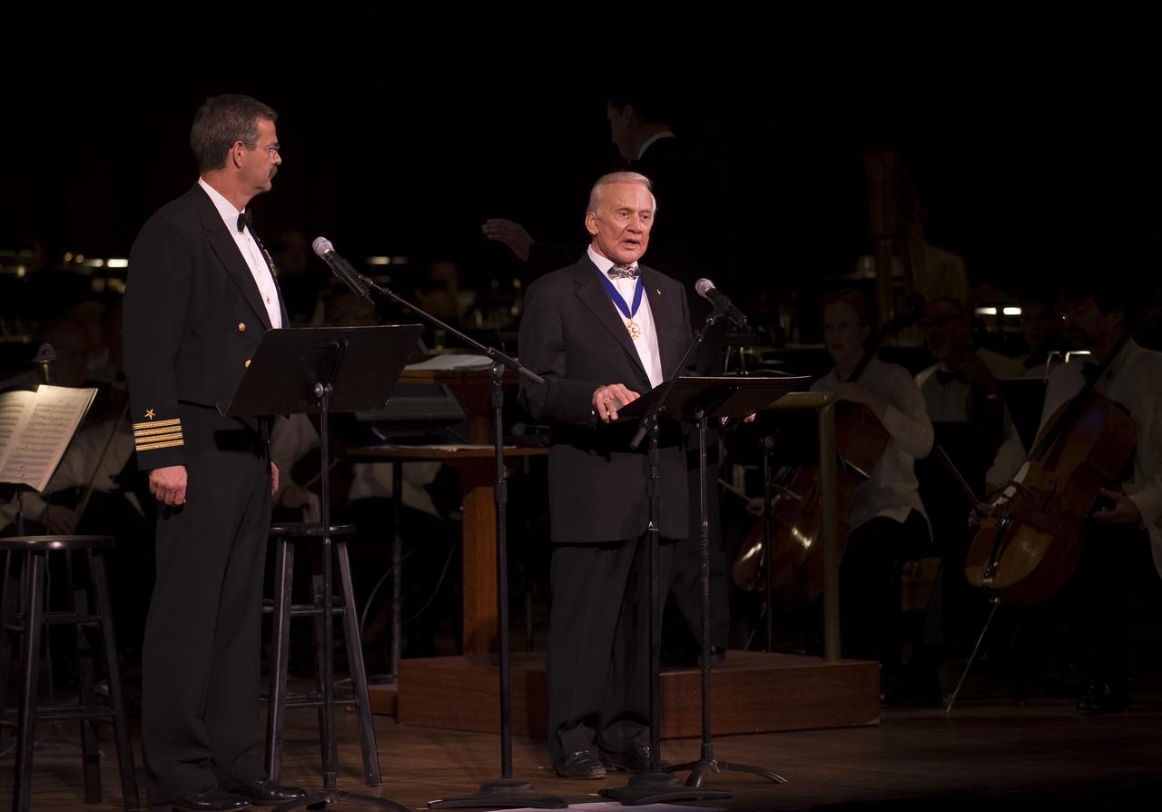 NASA astronaut Scott Altman, left, listens as Apollo 11 astronaut Buzz Aldrin reads an introduction to Gustav Holst: The Planets Suite during the "Salute to Apollo" ceremony at the Kennedy Center for the Performing Arts, Saturday, July 18, 2009 in Washington. The event was part of NASA's week long celebration of the Apollo 40th Anniversary. Photo Credit: (NASA/Bill Ingalls)