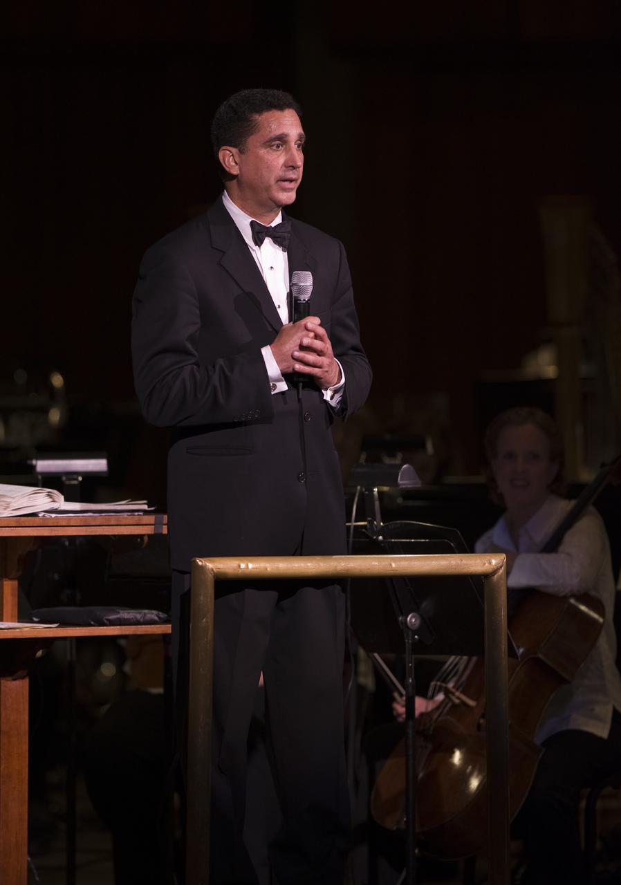 Emil de Cou, Conductor of the National Symphony Orchestra, talks to the audience during the "Salute to Apollo" ceremony at the Kennedy Center for the Performing Arts, Saturday, July 18, 2009 in Washington. The event was part of NASA's week long celebration of the Apollo 40th Anniversary. Photo Credit: (NASA/Bill Ingalls)