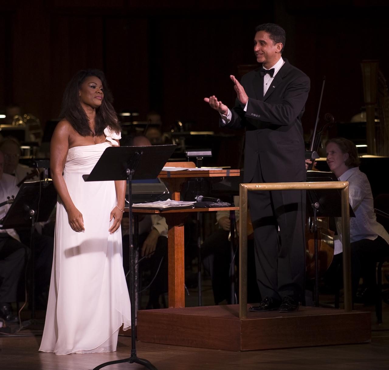 Emil de Cou, Conductor of the National Symphony Orchestra, applauds after Opera singer Denyce Graves' perfomance during the "Salute to Apollo" ceremony at the Kennedy Center for the Performing Arts, Saturday, July 18, 2009 in Washington. The event was part of NASA's week long celebration of the Apollo 40th Anniversary. Photo Credit: (NASA/Bill Ingalls)