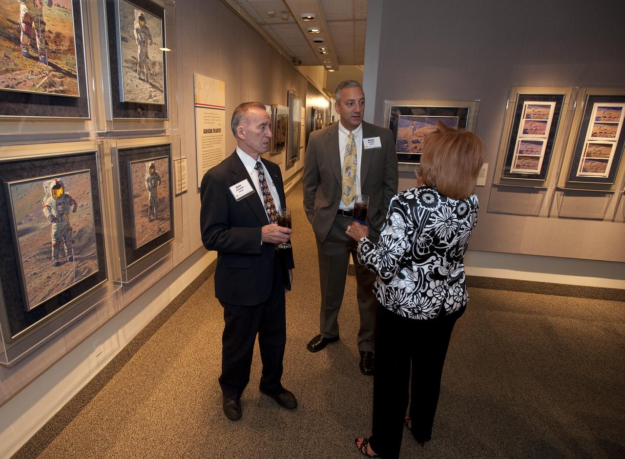 NASA Apollo 7 Astronaut Walt Cunningham, left, and NASA STS-125 Mission Specialist Michael Massimino talk with another guest during the opening of "Alan Bean: Painting Apollo, First Artist on Another World" by NASA Apollo 12 Astronaut and Artist Alan Bean at the National Air and Space Museum, Monday, July 20, 2009 in Washington. The show opening coincided with the 40th anniversary celebration of Apollo. Photo Credit: (NASA/Bill Ingalls)