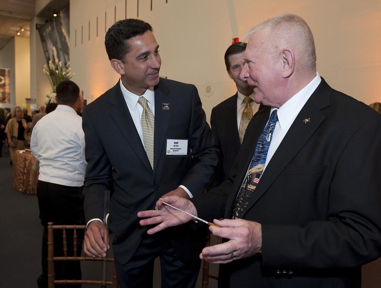 National Symphony Orchestra Conductor Emil de Cou, left, presents a ceremonial baton to retired NASA Flight Director and manager Gene Kranz at the Apollo 40th anniversary celebration held at the National Air and Space Museum, Monday, July 20, 2009 in Washington. Kranz was a guest conductor the night before at the Kennedy Center for the Performing Arts. Photo Credit: (NASA/Bill Ingalls)