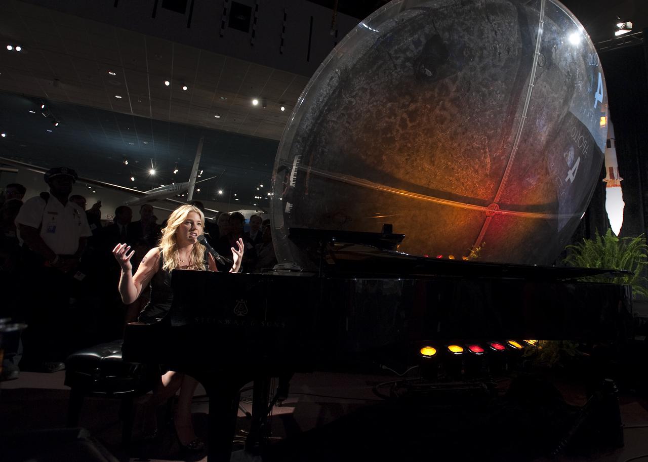 Jazz pianist and singer Diana Krall gives an introduction prior to her performance at the Apollo 40th anniversary celebration held at the National Air and Space Museum, Monday, July 20, 2009 in Washington. Ms. Krall's piano was staged right next to the Apollo 11 Command Capsule.  Photo Credit: (NASA/Bill Ingalls)