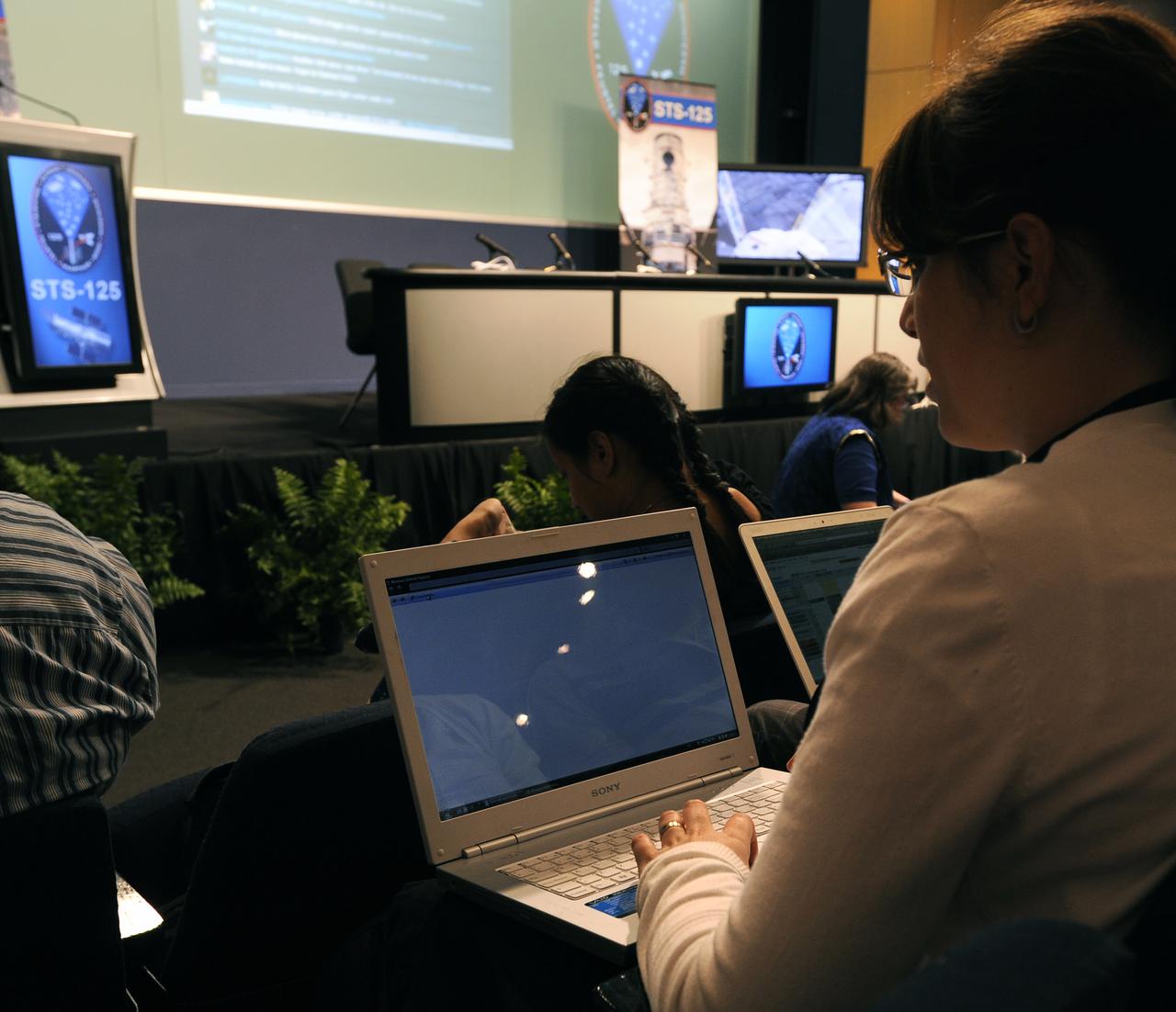 Guests at NASA Headquarters in Washington, DC prepare for a Tweetup on July 21, 2009. Nearly 200 of NASA’s Twitter followers are in attendance, which features a presentation and a question and answer session with the crew of the STS-125 shuttle mission to repair the Hubble Space Telescope. Photo Credit: (Carla Cioffi)
