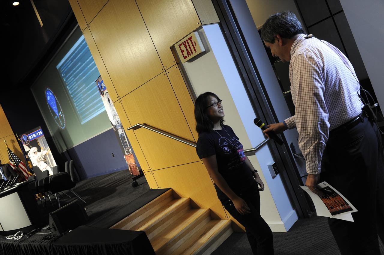 Al Feinberg from NASA Television, interviews a guest at the NASA Tweetup event held at NASA Headquarters, July 21, 2009 in Washington. Nearly 200 of NASA’s Twitter followers are in attendance, which features a presentation and a question and answer session with the crew of the STS-125 shuttle mission to repair the Hubble Space Telescope.  Photo Credit: (Carla Cioffi)
