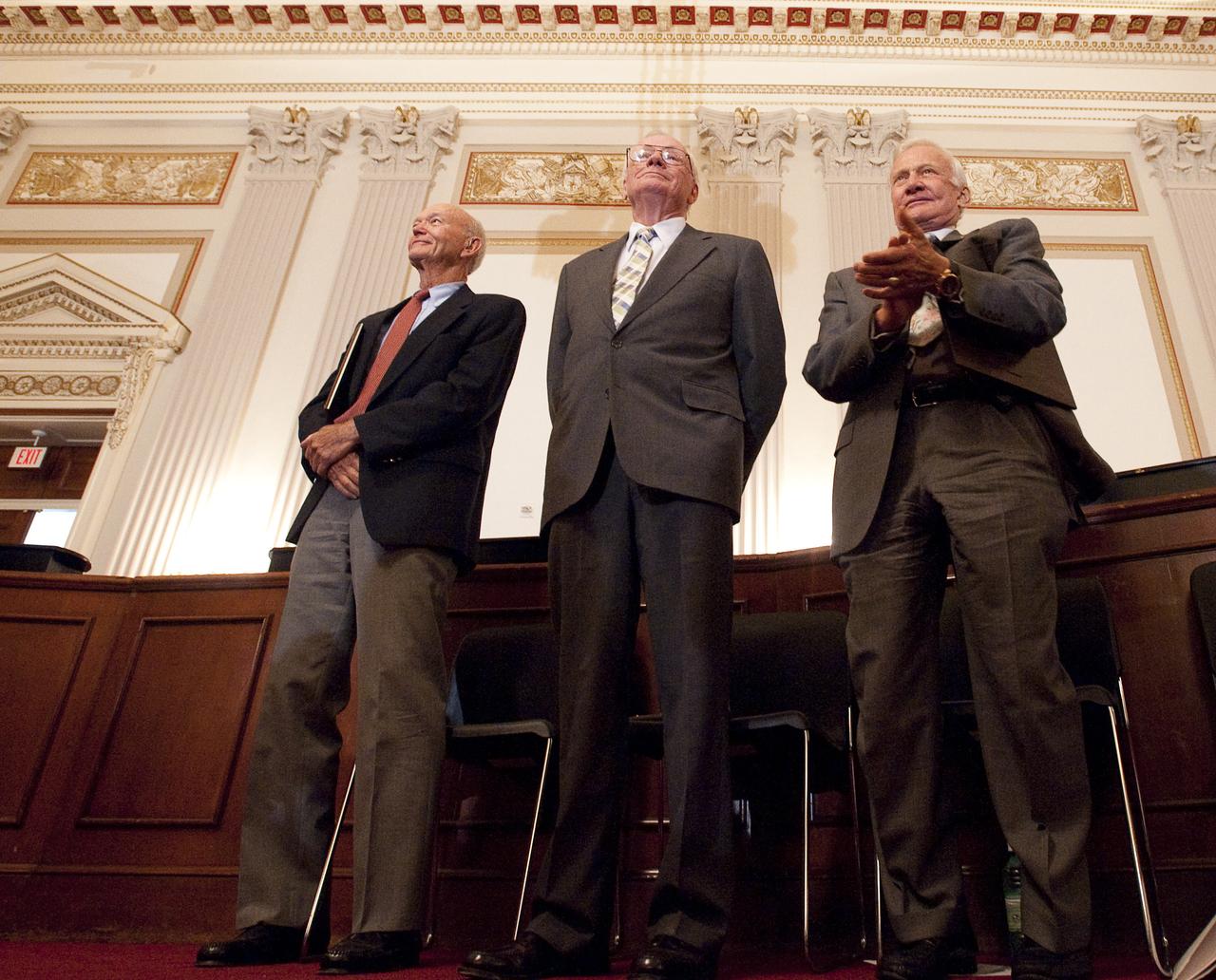 Apollo 11 Astronauts, from left, Michael Collins, Neil Armstrong, and Buzz Aldrin stand in recognition of Astronaut John Glenn during the U.S House of Representatives Committee on Science and Technology tribute to the Apollo 11 Astronauts at the Cannon House Office Building on Capitol Hill, Tuesday, July 21, 2009 in Washington.  The committee presented the three Apollo 11 astronauts with a framed copy of House Resolution 607 honoring their achievement, and announced passage of legislation awarding them and John Glenn the Congressional Gold Medal.  Photo Credit: (NASA/Bill Ingalls)