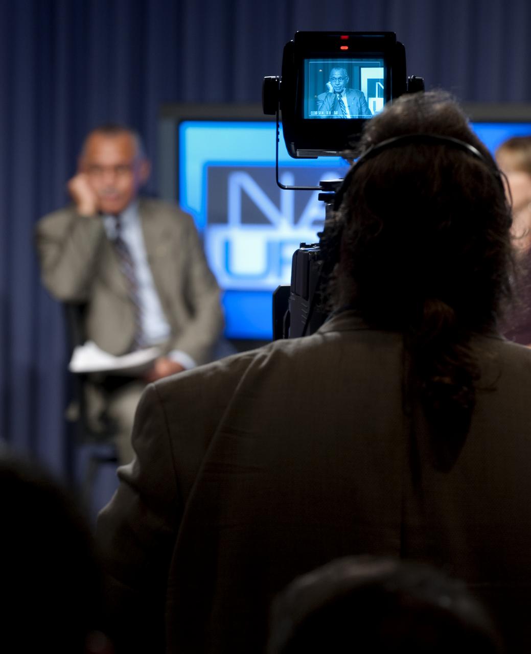 NASA Administrator Charles F. Bolden Jr. is seen through a television camera monitor during his first NASA Update,Tuesday, July 21, 2009, at NASA Headquarters in Washington. Bolden, NASA's 12th Administrator, was joined by Deputy Administrator Lori Garver where they took the time to introduce themselves and outline their vision for the agency going forward. No questions were taken during the session. Photo Credit: (NASA/Bill Ingalls)