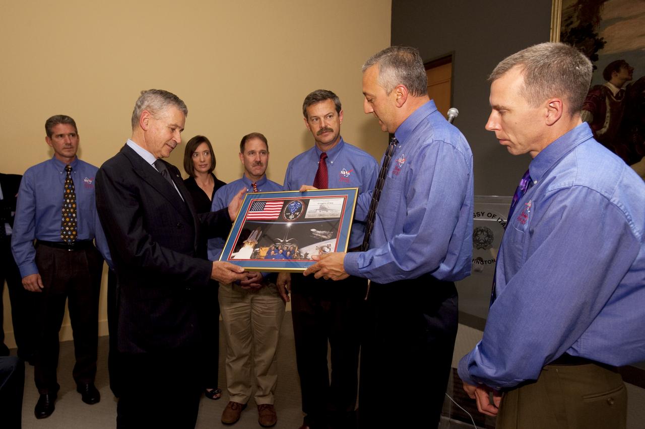 Italian Ambassador Giovanni Castellaneta, second from left, is presented with a montage by STS-125 Mission Specialist Mike Massimino, second from right, during a visit by the crew of STS-125 to the Embassy of Italy in Washington, Thursday, July 23, 2009. Other crew members, from left are Mission Specialists, Michael Good, Megan McArthur, John Grunsfeld, Commander Scott Altman and Andrew Feustel, far right. Photo Credit: (NASA/Bill Ingalls)