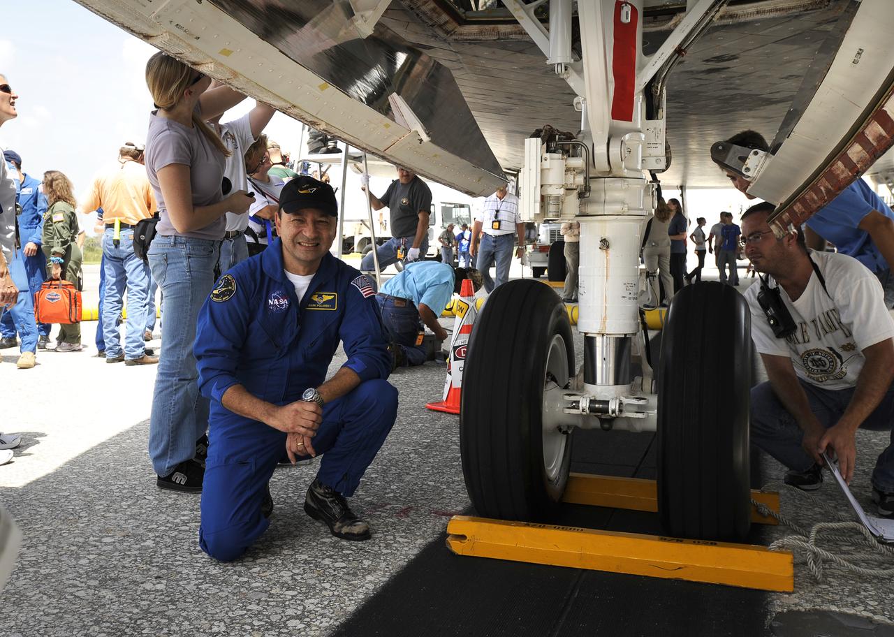 Astronaut Mark Polansky, STS-127 mission commander, poses for a photograph by the front wheel of the space shuttle Endeavour shortly after it and its crew landed, Friday, July 31, 2009 at NASA's Kennedy Space Center in Cape Canaveral, Fla., completing a 16-day journey of more than 6.5 million miles. Endeavour delivered the final segment to the Japan Aerospace Exploration Agency's Kibo laboratory and a new crew member to the International Space Station. Photo Credit: (NASA/Bill Ingalls)