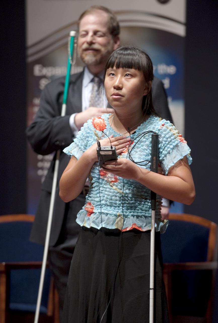 NAME sings the National Anthem at a ceremony where senior NASA officials presented the NFB with two Louis Braille Bicentennial Silver Dollars that flew on Space Shuttle Atlantis' mission (STS-125) to the Hubble Space Telescope in May 2009, Friday evening, July 31, 2009, at the Capitol Visitors Center in Washington. Photo Credit: (NASA/Paul E. Alers)