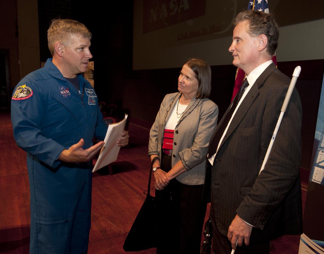 NASA astronaut Greg Johnson, left, speaks with Dr. Marc Mauer, president of the National Federation of the Blind, right, prior to a ceremony where senior NASA officials presented the NFB with two Louis Braille Bicentennial Silver Dollars that flew on Space Shuttle Atlantis' mission (STS-125) to the Hubble Space Telescope in May 2009, Friday evening, July 31, 2009, at the Capitol Visitors Center in Washington. Photo Credit: (NASA/Paul E. Alers)