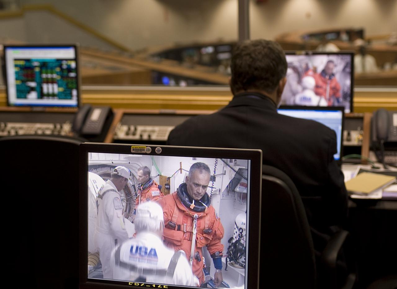 NASA Astronaut John "Danny" Olivas is seen preparing to board the space shuttle Discovery at pad 39a on a monitor in Firing Room Four of the Kennedy Space Center at Cape Canaveral, Fla., Monday, Aug. 24, 2009.  Discovery is scheduled to launch Tuesday, Aug. 25, 2009 at 1:36 a.m. EDT and will carry the Leonardo supply module to the International Space Station during STS-128, along with a new crew member for the station, Nicole Stott.  Photo Credit: (NASA/Bill Ingalls)