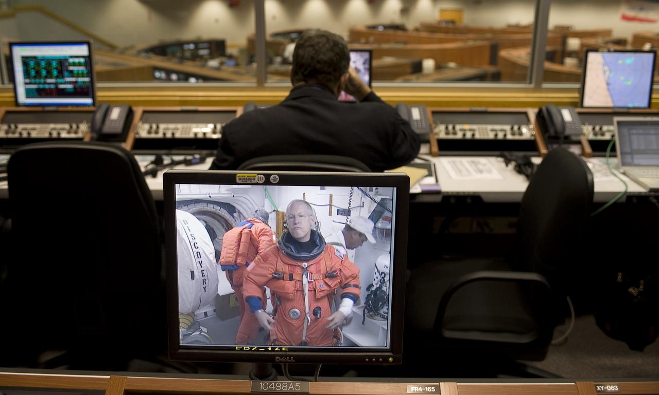 NASA Astronaut Patrick Forrester is seen preparing to board the space shuttle Discovery at pad 39a on a monitor in Firing Room Four of the Kennedy Space Center at Cape Canaveral, Fla., Monday, Aug. 24, 2009.  Discovery is scheduled to launch Tuesday, Aug., 25, 2009 at 1:36 a.m. EDT and will carry the Leonardo supply module to the International Space Station during STS-128, along with a new crew member for the station, Nicole Stott.  Photo Credit: (NASA/Bill Ingalls)