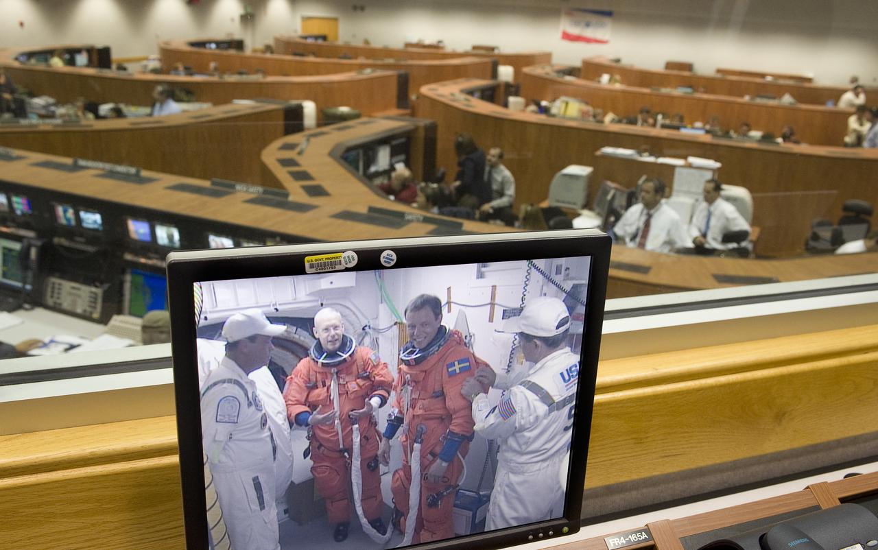 NASA Astronaut Patrick Forrester, left, and European Space Agency Astronaut Christer Fuglesang are seen preparing to board the space shuttle Discovery at pad 39a on a monitor in Firing Room Four of the Kennedy Space Center at Cape Canaveral, Fla., Monday, Aug. 24, 2009.  Discovery is scheduled to launch Tuesday, Aug., 25, 2009 at 1:36 a.m. EDT and will carry the Leonardo supply module to the International Space Station during STS-128, along with a new crew member for the station, Nicole Stott.  Photo Credit: (NASA/Bill Ingalls)