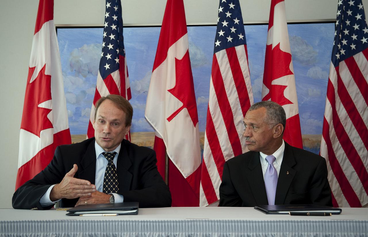 NASA Administrator Charles Bolden, right, and Canadian Space Agency President Steve MacLean sign a framework agreement on civil space cooperation, Wednesday, Sept. 9, 2009, at the Canadian Embassy in Washington, DC. Photo Credit: (NASA/Bill Ingalls)