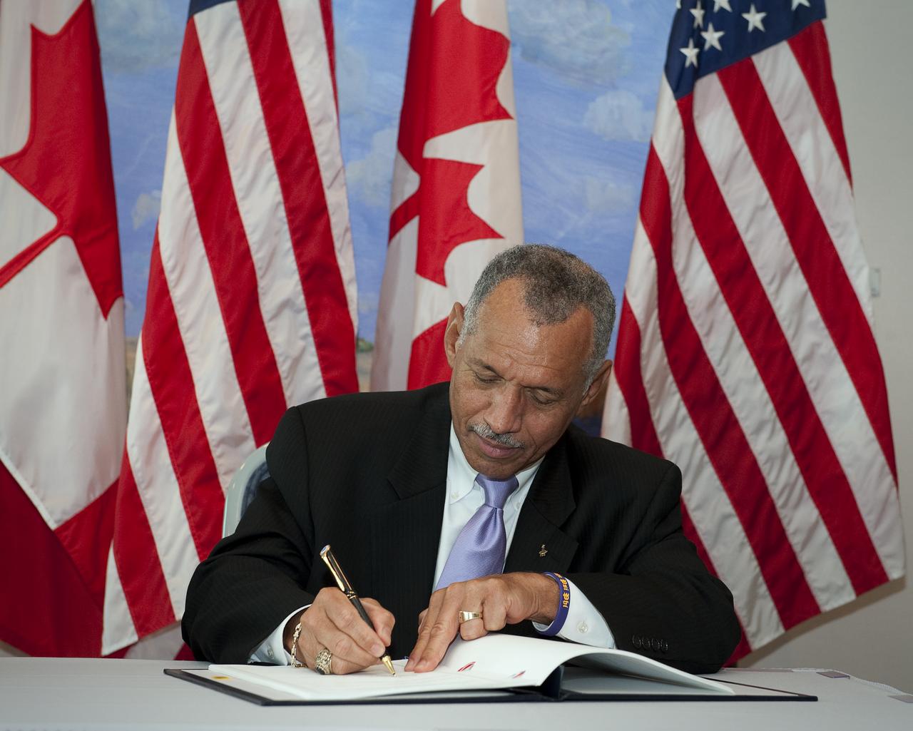 NASA Administrator Charles Bolden signs a framework agreement on civil space cooperation between the U.S. and Canada, Wednesday, Sept. 9, 2009, at the Canadian Embassy in Washington, DC. Photo Credit: (NASA/Bill Ingalls) 
