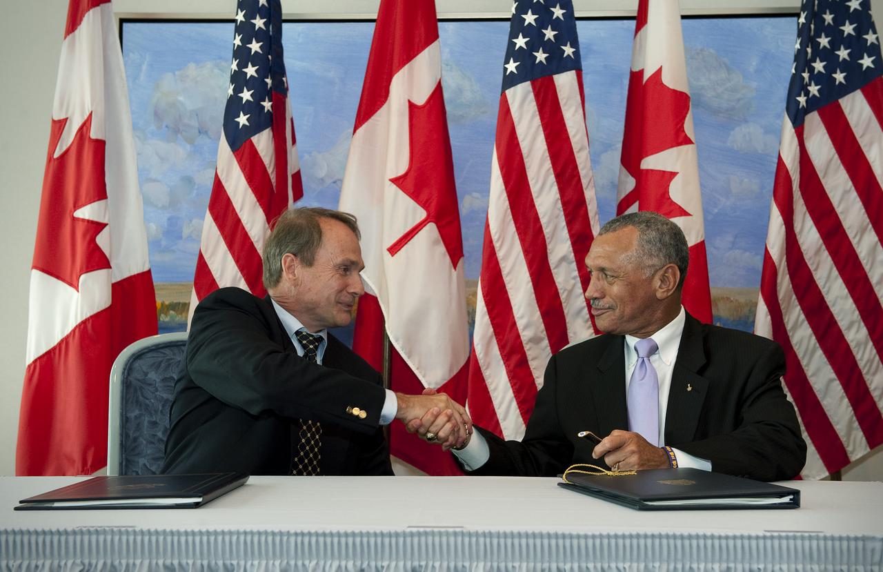 NASA Administrator Charles Bolden, right, and Canadian Space Agency President Steve MacLean shake hands after signing a framework agreement on civil space cooperation, Wednesday, Sept. 9, 2009, at the Canadian Embassy in Washington, DC. Photo Credit: (NASA/Bill Ingalls)