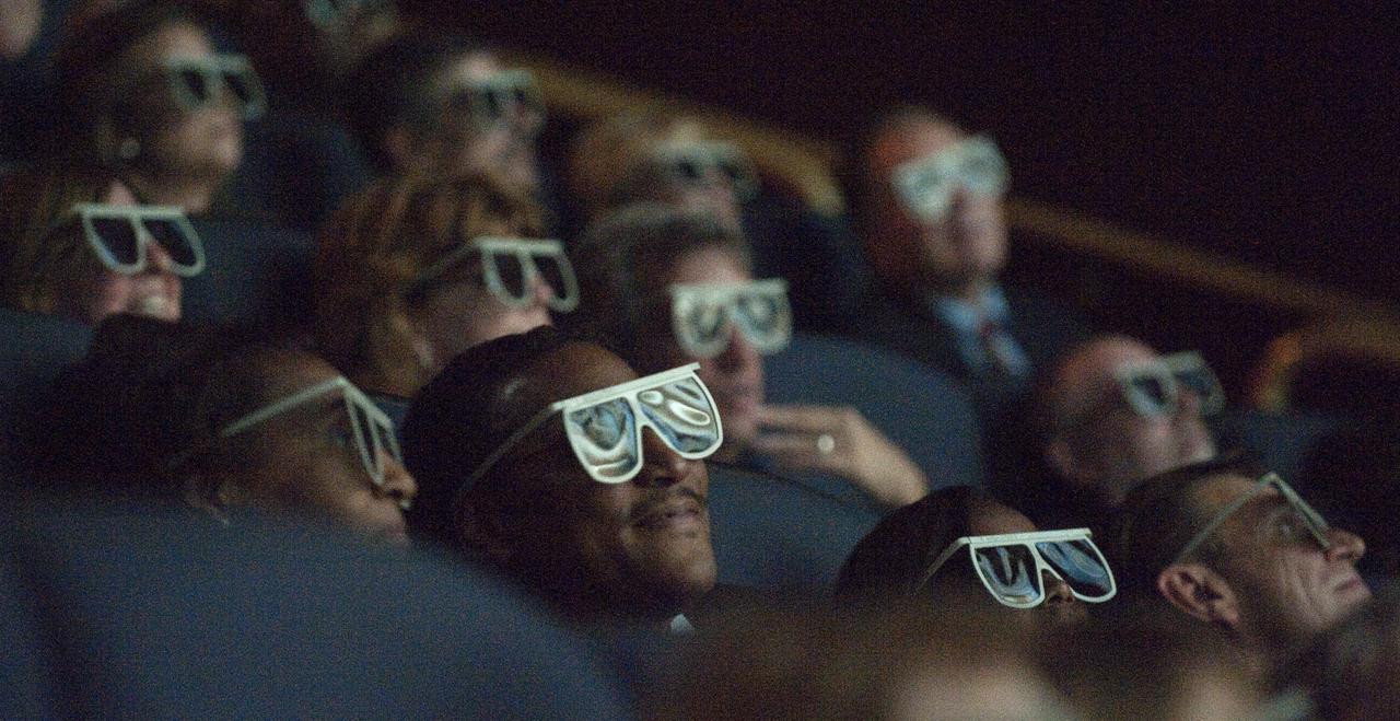 Images from the Hubble Space Telescope are reflected on special glasses as people observe the newly released pictures Wednesday evening, Sept. 9, 2009, during a celebration of the Hubble Legacy at the National Air and Space Museum in Washington. Astronomers declared the telescope a fully rejuvenated observatory with the release Wednesday of observations from four of its six operating science instruments. Photo Credit: (NASA/Bill Ingalls)