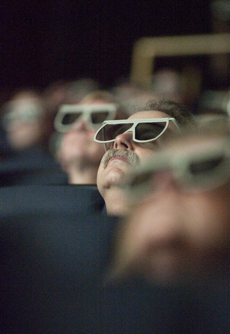 Unidentified people observe newly released images from the Hubble Space Telescope through special glasses, Wednesday evening, Sept. 9, 2009, during a celebration of the Hubble Legacy at the National Air and Space Museum in Washington. Astronomers declared the telescope a fully rejuvenated observatory with the release Wednesday of observations from four of its six operating science instruments. Photo Credit: (NASA/Bill Ingalls)