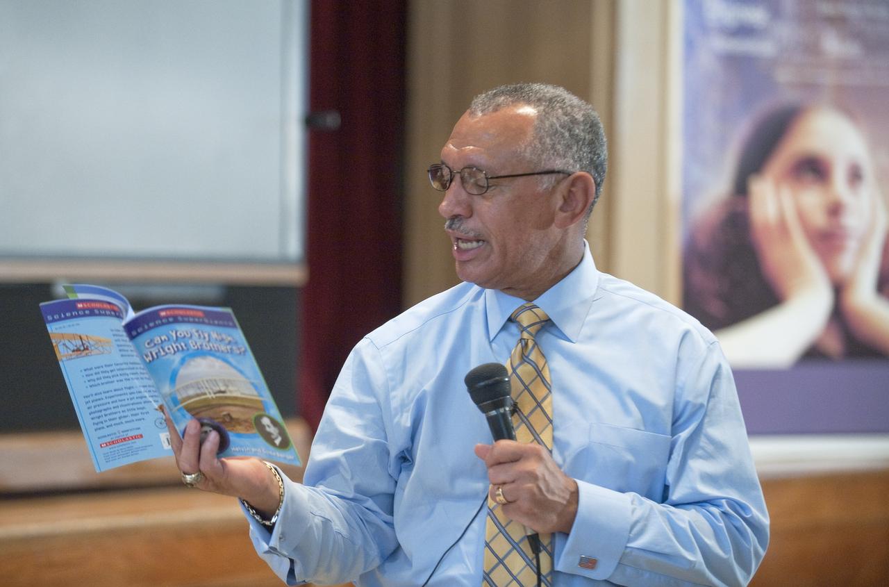 NASA Administrator Charles F. Bolden reads a passage from the book "Can You Fly High Wright Brothers?" while visiting with students at Davis Elementary School, Friday, Sept. 11, 2009, in Washington. Bolden spent time with approximately 120 students in third, fourth and fifth grade  talking about science, technology, mathematics and engineering as part of the National Day of Service and Remembrance. Photo Credit: (NASA/Paul E. Alers)
