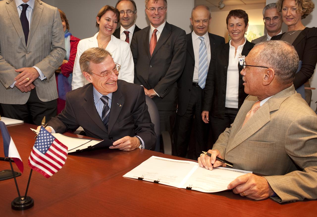 French Space Agency President Yannick d’Escatha, left, and NASA Administrator Charles Bolden joke with each other as they sign four agreements in support of U.S. and French space cooperation during a ceremony at NASA headquarters in Washington, Thursday, Sept. 17, 2009. Photo Credit: (NASA/Bill Ingalls)