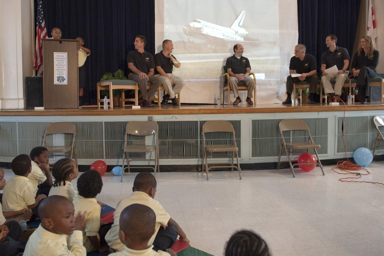 Ajani Young, a fourth grade student at Anne Beers Elementary school, at podium, introduces the crew of STS-127 during their visit, Thursday, Sept. 24, 2009, in Washington. Seated from left are crew members, Chris Cassidy, Doug Hurley, Commander Mark Polansky, David Wolf, Tom Marshburn and Canadian Space Agency astronaut Julie Payette. Photo Credit: (NASA/Paul E. Alers)