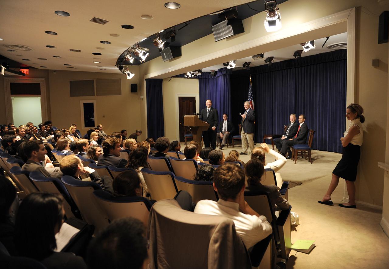 STS-127 Commander Mark Polansky, at podium, and crew member David Wolf, standing right, answer questions from White House interns at the Eisenhower Executiive Office Building in Washington, Thursday, Sept. 24, 2009. Seated from left are crew members Christopher Cassidy, Douglas Hurley and Thomas Marshburn. Photo Credit: (NASA/Paul E. Alers)