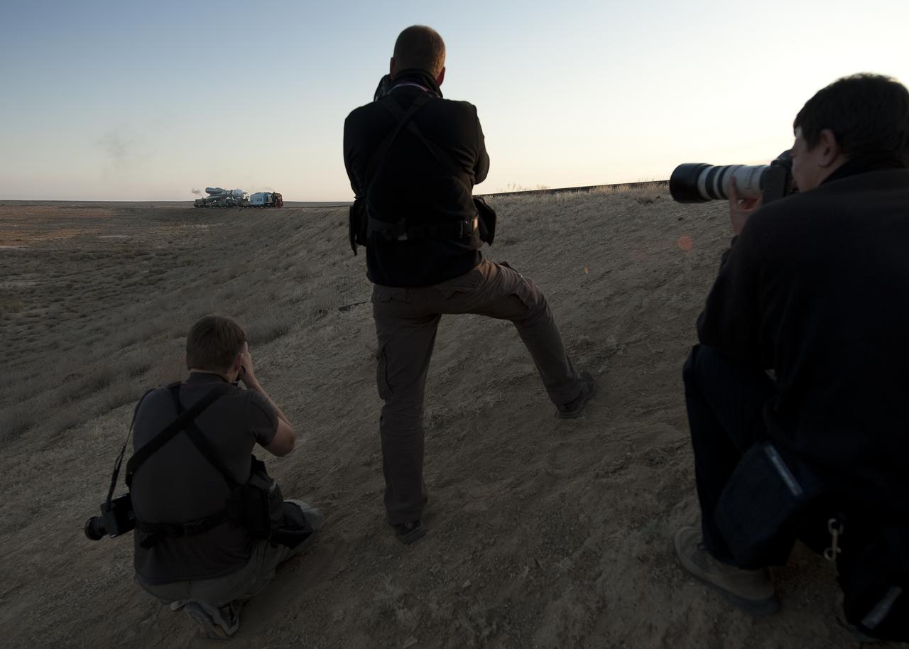 Photojournalists photograph the Soyuz rocket as it is rolled out to the launch pad Monday, Sept. 28, 2009 at the Baikonur Cosmodrome in Kazakhstan.  The Soyuz is scheduled to launch the crew of Expedition 21 and a spaceflight participant on Sept. 30, 2009.  Photo Credit: (NASA/Bill Ingalls)