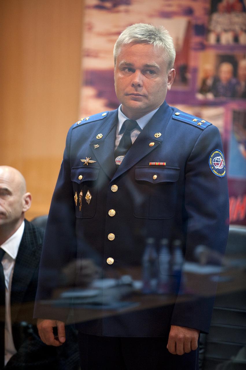 Expedition 21 Flight Engineer Maxim Suraev stands as he is recognized during the State Commission meeting to approve the Soyuz launch of Suraev, Expedition 21 Flight Engineer Jeffrey N. Williams, and Spaceflight Participant Guy Laliberté on Tuesday, Sept. 29, 2009 in Baikonur, Kazakhstan. The crew is kept in a separate room with a glass window in order to help maintain their health. Photo Credit: (NASA/Bill Ingalls)