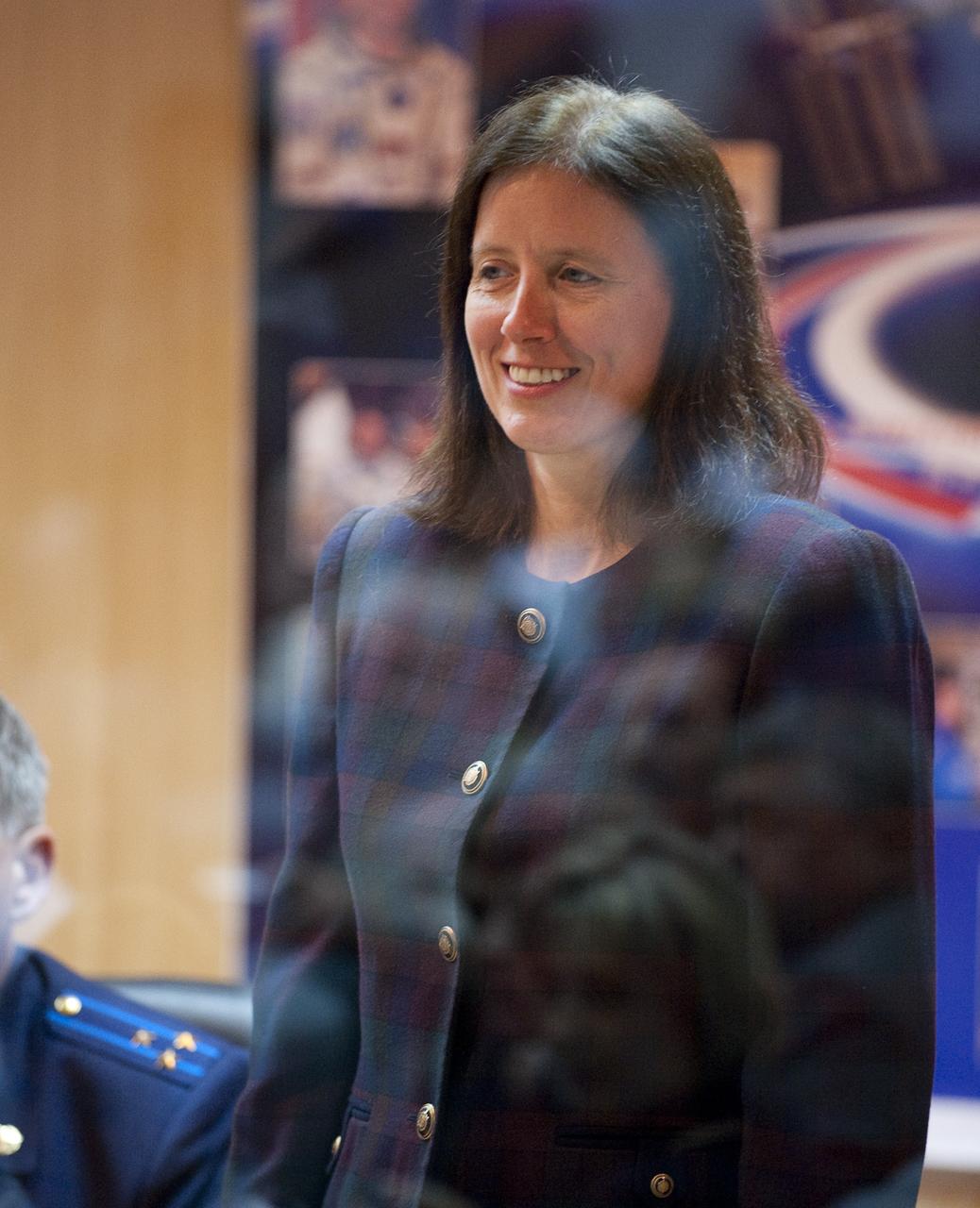Expedition 21 Backup Flight Engineer Shannon Walker stands as she is recognized during the State Commission meeting to approve the Soyuz launch of Expedition 21 Flight Engineer Jeffrey N. Williams, Expedition 21 Flight Engineer Maxim Suraev, and Spaceflight Participant Guy Laliberté on Tuesday, Sept. 29, 2009 in Baikonur, Kazakhstan. The crew is kept in a separate room with a glass window in order to help maintain their health. Photo Credit: (NASA/Bill Ingalls)