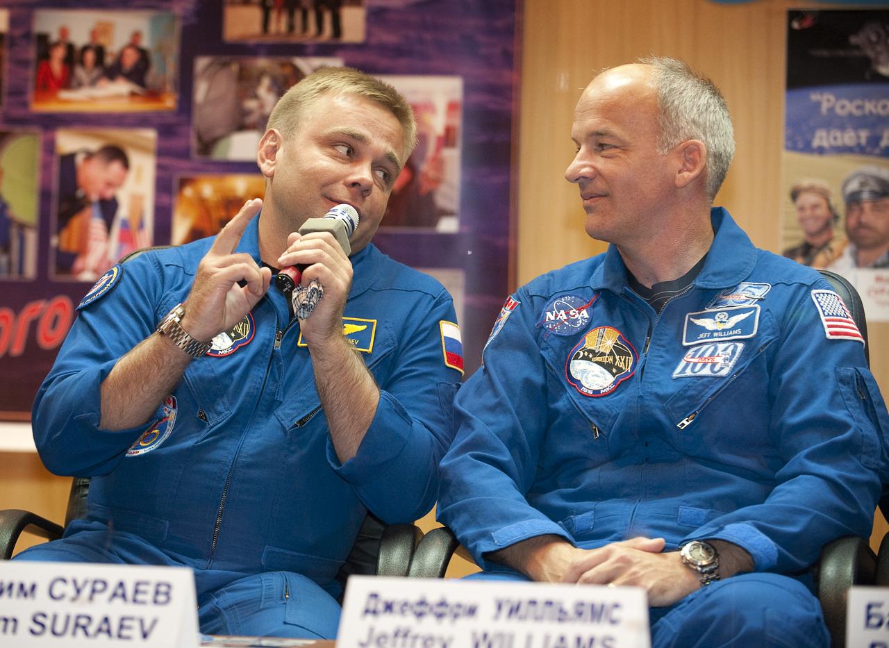 Expedition 21 Flight Engineer Maxim Suraev, left, answers a reporter's question while looking at Expedition 21 Flight Engineer Jeffrey N. Williams during a press conference, Tuesday, Sept. 29, 2009 at the Cosmonaut Hotel in Baikonur, Kazakhstan. Suraev is scheduled to launch onboard a Soyuz rocket to the International Space Station (ISS) with Williams and Spaceflight Participant Guy Laliberté on Wednesday, Sept. 30, 2009 from the Baikonur Cosmodrome in Kazakhstan. Photo Credit: (NASA/Bill Ingalls)