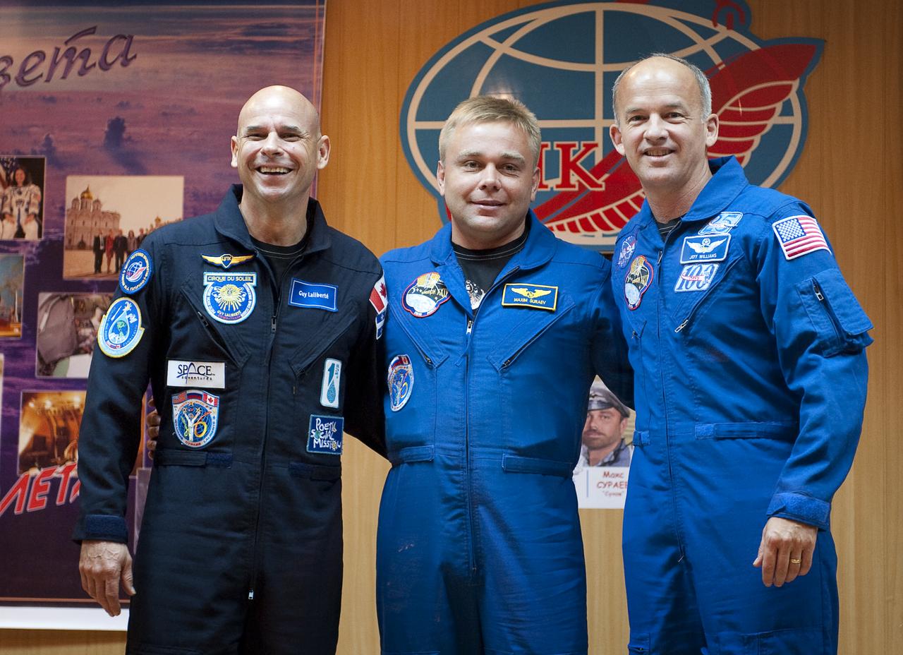 Spaceflight Participant Guy Laliberté, left, Expedition 21 Flight Engineer Maxim Suraev, center, and Expedition 21 Flight Engineer Jeffrey N. Williams pose for a group photograph at the end of the press conference, Tuesday, Sept. 29, 2009 at the Cosmonaut Hotel in Baikonur, Kazakhstan. Photo Credit: (NASA/Bill Ingalls)