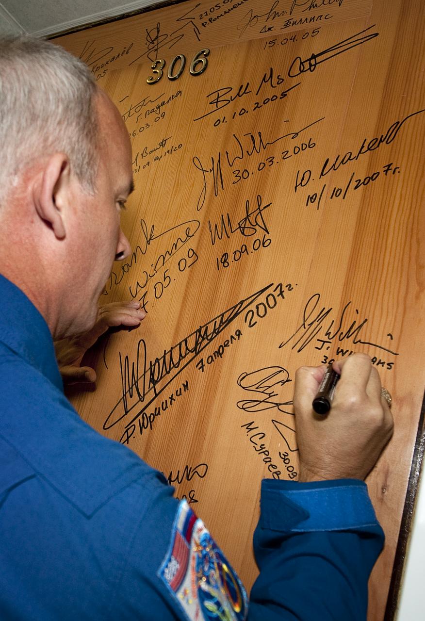 Expedition 21 Flight Engineer Jeffrey N. Williams performs the traditional door signing Wednesday, Sept. 30, 2009 at the Cosmonaut Hotel in Baikonur, Kazakhstan. Williams was launched onboard the Soyuz rocket later that day with Expedition 21 Flight Engineer Maxim Suraev and Spaceflight Participant Guy Laliberté on a mission to the International Space Station (ISS).  Photo Credit: (NASA/Bill Ingalls)