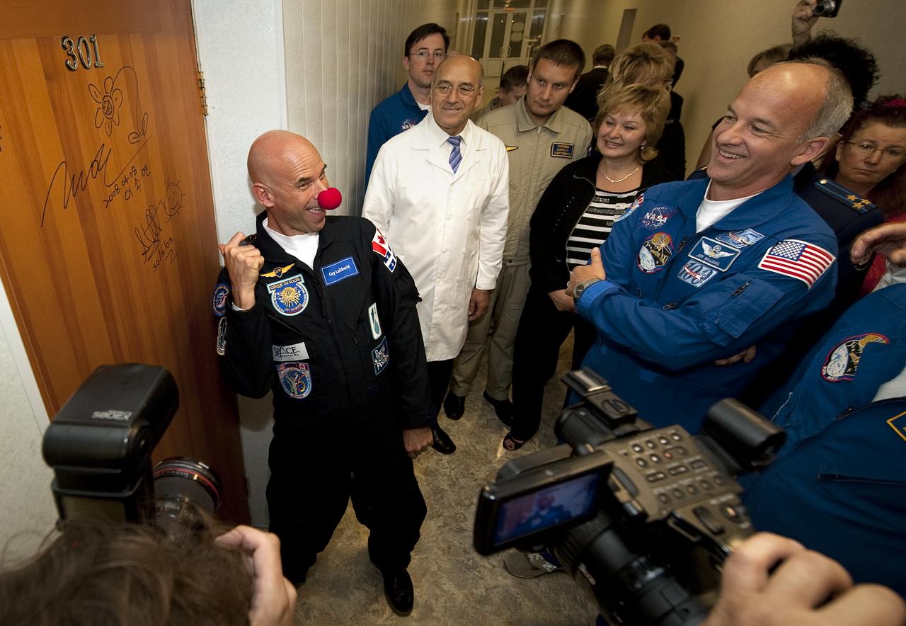Spaceflight Participant Guy Laliberté jokes after performing the traditional door signing Wednesday, Sept. 30, 2009 at the Cosmonaut Hotel in Baikonur, Kazakhstan. Lalibreté was launched onboard the Soyuz rocket later that day with Expedition 21 Flight Engineer Expedition 21 Flight Engineer Jeffrey N. Williams and Expedition 21 Flight Engineer Maxim Suraev and on a mission to the International Space Station (ISS).  Photo Credit: (NASA/Bill Ingalls)