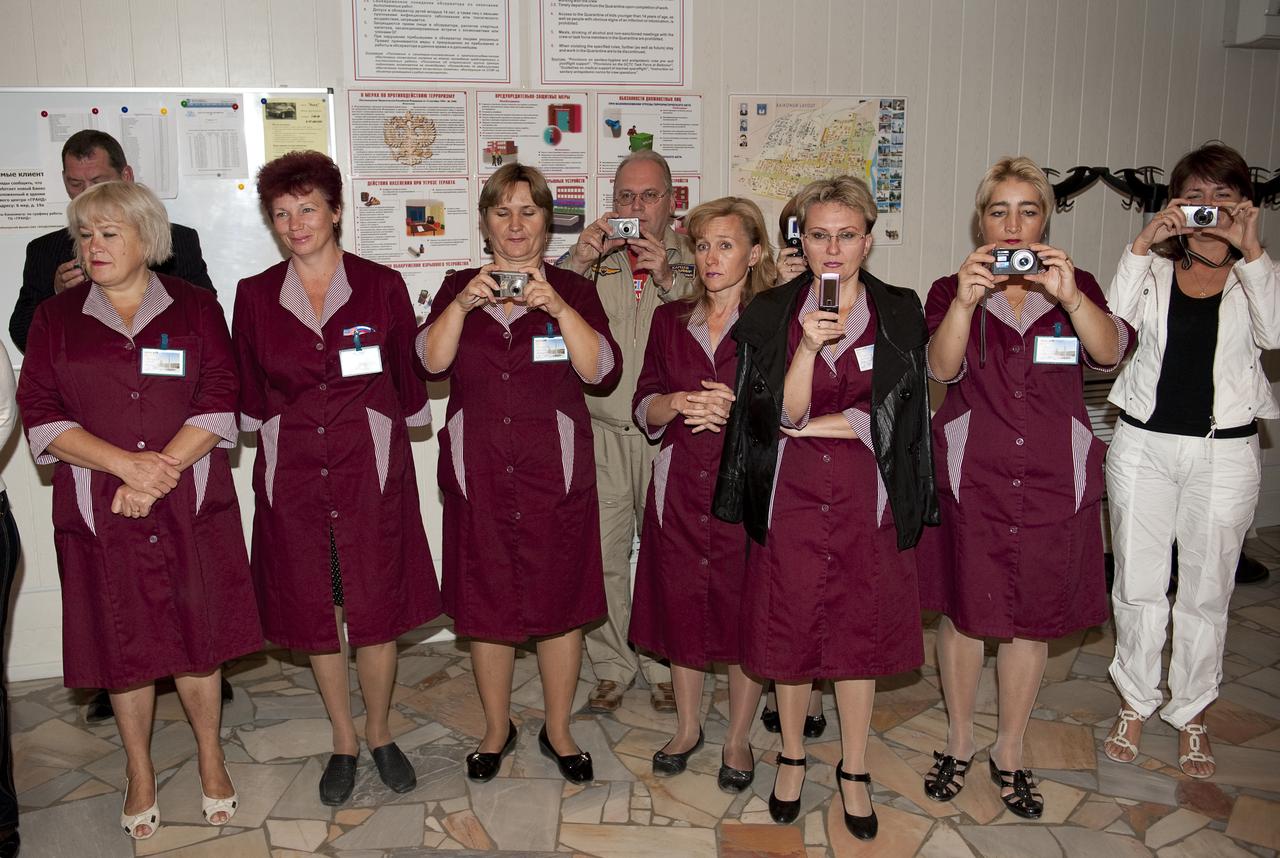 Cosmonaut Hotel staff wait to watch the departure from the hotel of Expedition 21 Flight Engineer Maxim Suraev, Expedition 21 Flight Engineer Jeffrey N. Williams and Spaceflight Participant Guy Laliberté on the morning of their Soyuz launch to the International Space Station on Wednesday, Sept. 30, 2009 in Baikonur, Kazakhstan. Photo Credit: (NASA/Bill Ingalls)
