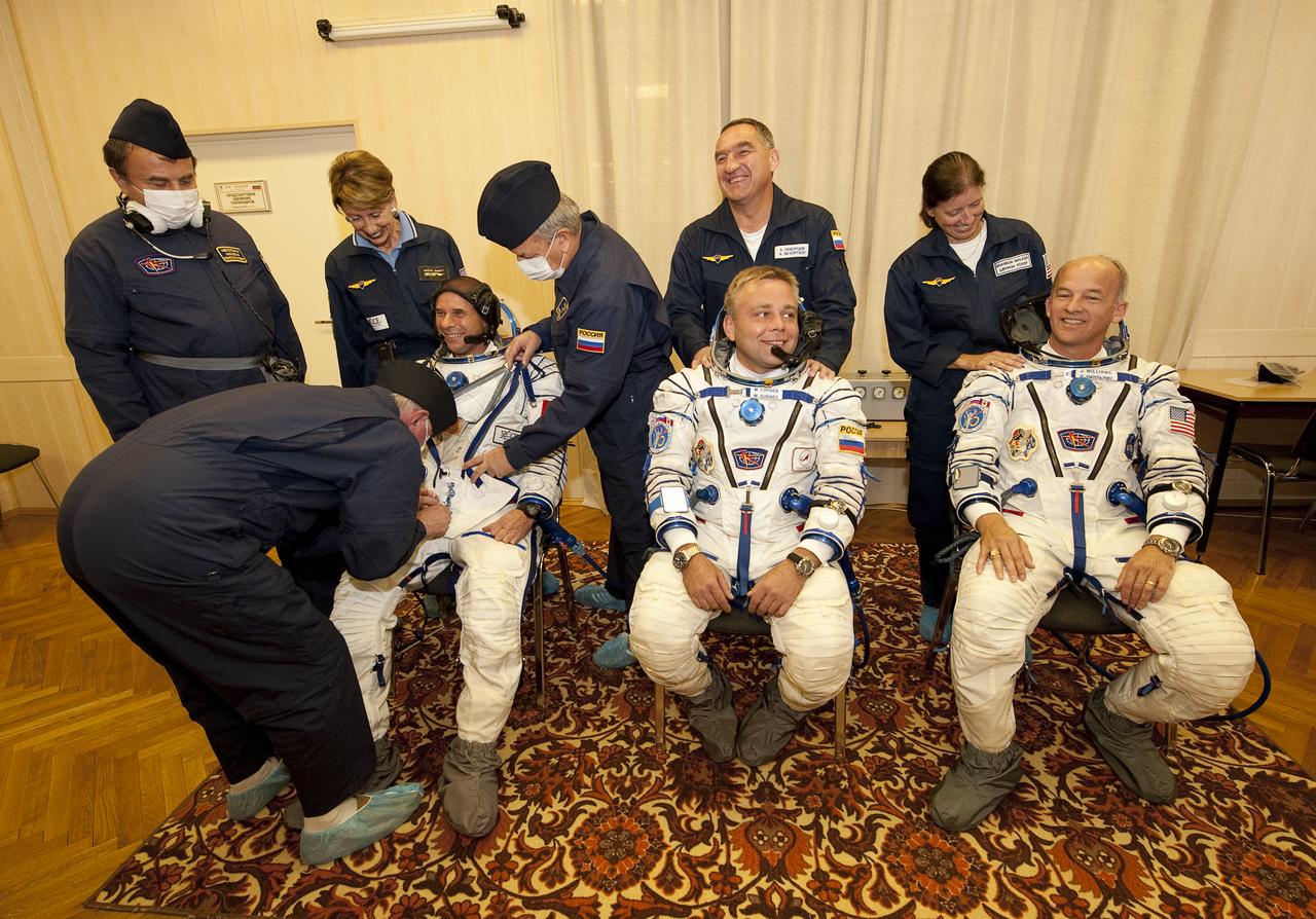 Spaceflight Participant Guy Laliberté, front left, Expedition 21 Flight Engineer Maxim Suraev, front center, and Expedition 21 Flight Engineer Jeffrey N. Williams prepare to have their Russian Sokol suits pressure tested while the backup crew members look on, from back left, Backup Spaceflight Participant Barbara Barrett, backup Expedition 21 Commander Aleksandr Skvortsov, and backup Expedition 21 Flight Engineer Shannon Walker, prior to the crews launch onboard a Soyuz rocket to the International Space Station on Wednesday, Sept. 30, 2009 in Baikonur, Kazakhstan. Photo Credit: (NASA/Bill Ingalls)