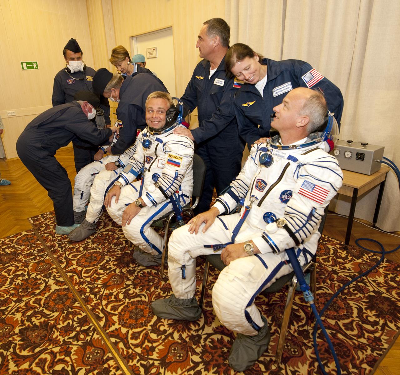 Spaceflight Participant Guy Laliberté, front left, Expedition 21 Flight Engineer Maxim Suraev, front center, and Expedition 21 Flight Engineer Jeffrey N. Williams prepare to have their Russian Sokol suits pressure tested while the backup crew members look on, from back left, Backup Spaceflight Participant Barbara Barrett, backup Expedition 21 Commander Aleksandr Skvortsov, and backup Expedition 21 Flight Engineer Shannon Walker, prior to the crews launch onboard a Soyuz rocket to the International Space Station on Wednesday, Sept. 30, 2009 in Baikonur, Kazakhstan. Photo Credit: (NASA/Bill Ingalls)