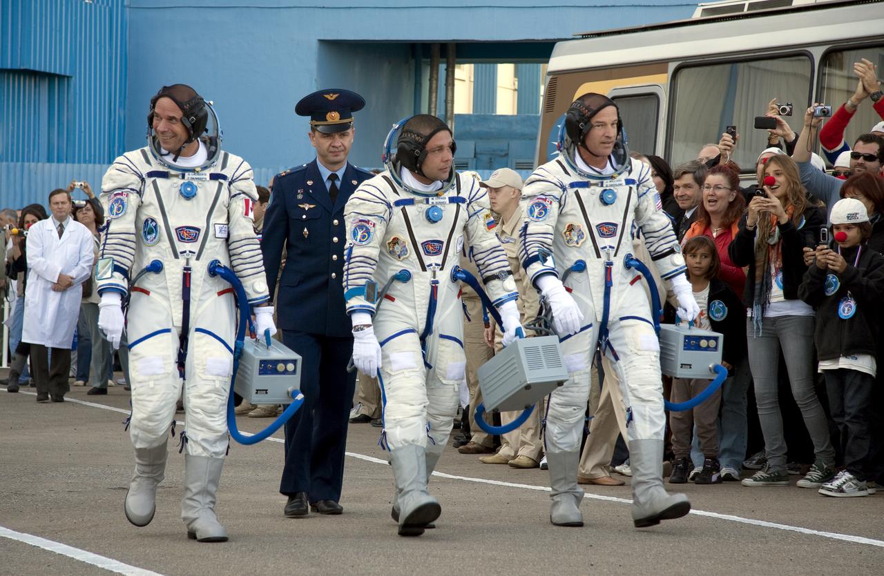 Spaceflight Participant Guy Laliberté, left, Expedition 21 Flight Engineer Maxim Suraev, center and Expedition 21 Flight Engineer Jeffrey N. Williams walk out to salute Head of the Russian Federal Space Agency, Anatoly Perminov prior to their launch onboard a Soyuz rocket to the International Space Station (ISS), Wednesday, Sept. 30, 2009 in Baikonur, Kazakhstan. Photo Credit: (NASA/Victor Zelentsov)
